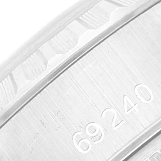 The image shows a close-up of the serial number engraving on the caseback of a Rolex Date 69240 Women's Stainless Steel Silver Dial 69240 Women's Stainless Steel Silver Dial model watch.