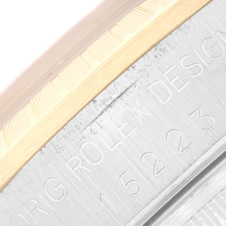The image shows a close-up of the casing with engraving on the Rolex Date 15223 Men's Steel and Gold (two tone) Black Dial 15223 Men's Steel and Gold (two tone) Black Dial model watch.