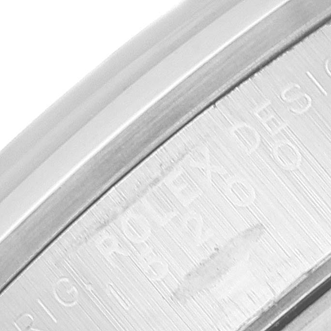 Close-up of the engraved bezel or side of a Rolex Date 15200 Men's Stainless Steel White Dial 15200 Men's Stainless Steel White Dial model watch, showing partial text and numbers.