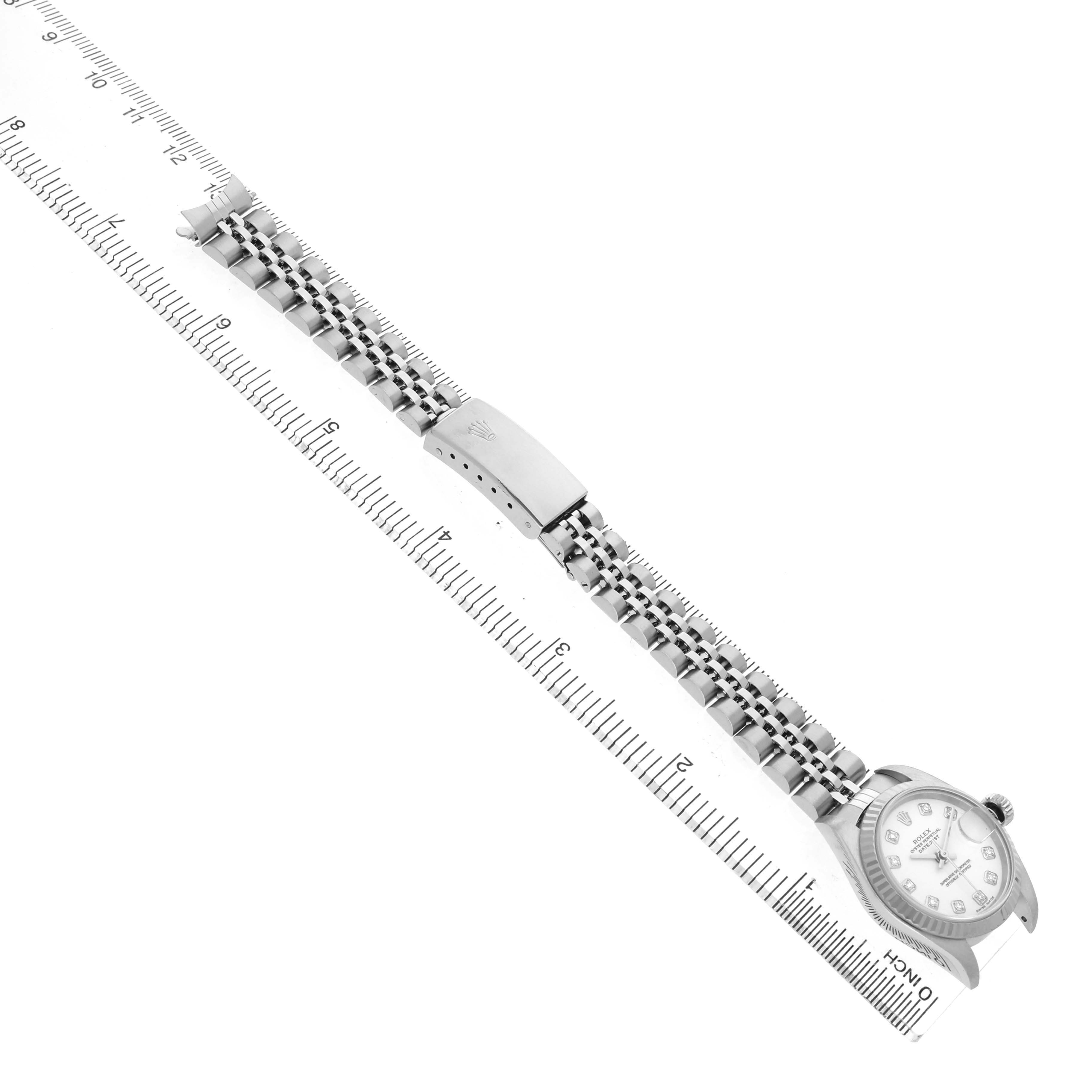 The Rolex Datejust 79174 Women's Stainless Steel White Dial watch is shown at an angle with the band extended, displaying the clasp, bracelet, and face.