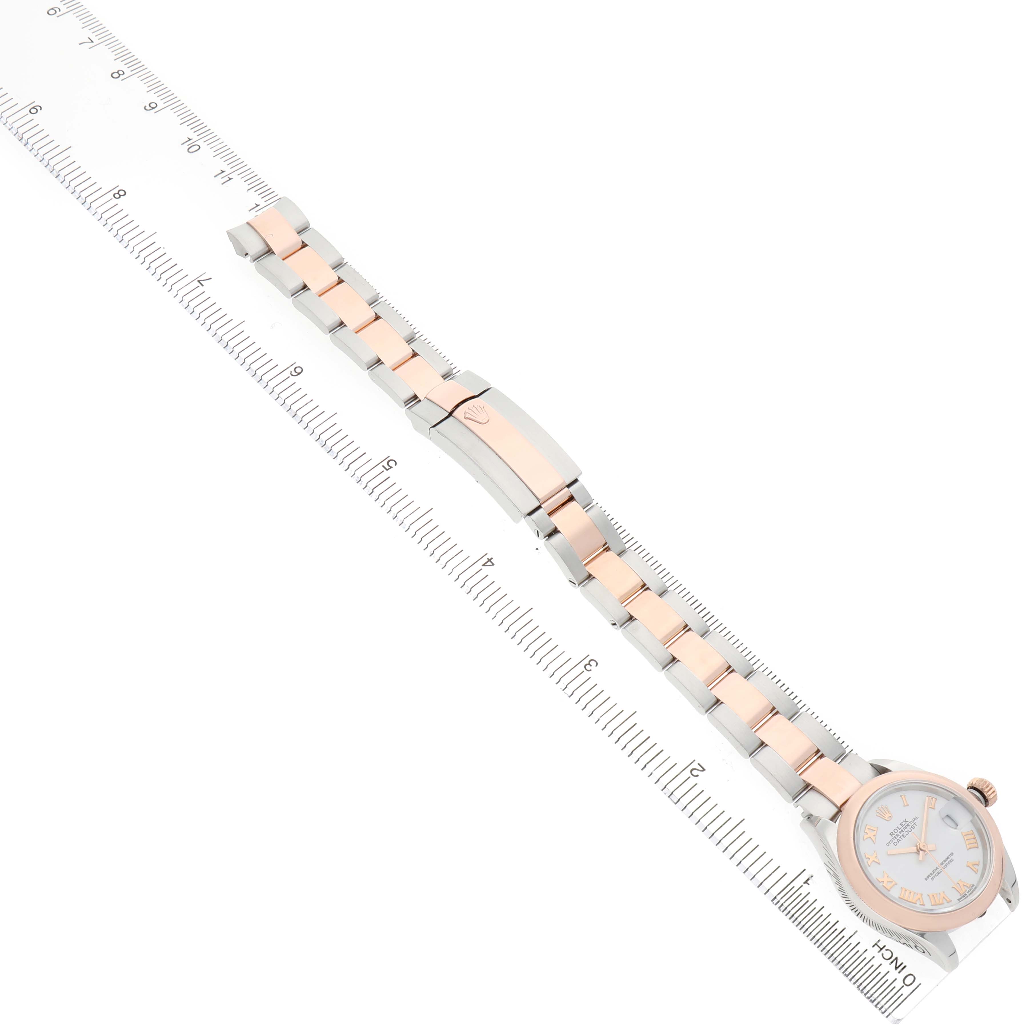 The Rolex Datejust 279161 Women's Stainless Steel White Dial watch is displayed flat, showcasing the bracelet and clasp, against a ruler for scale.