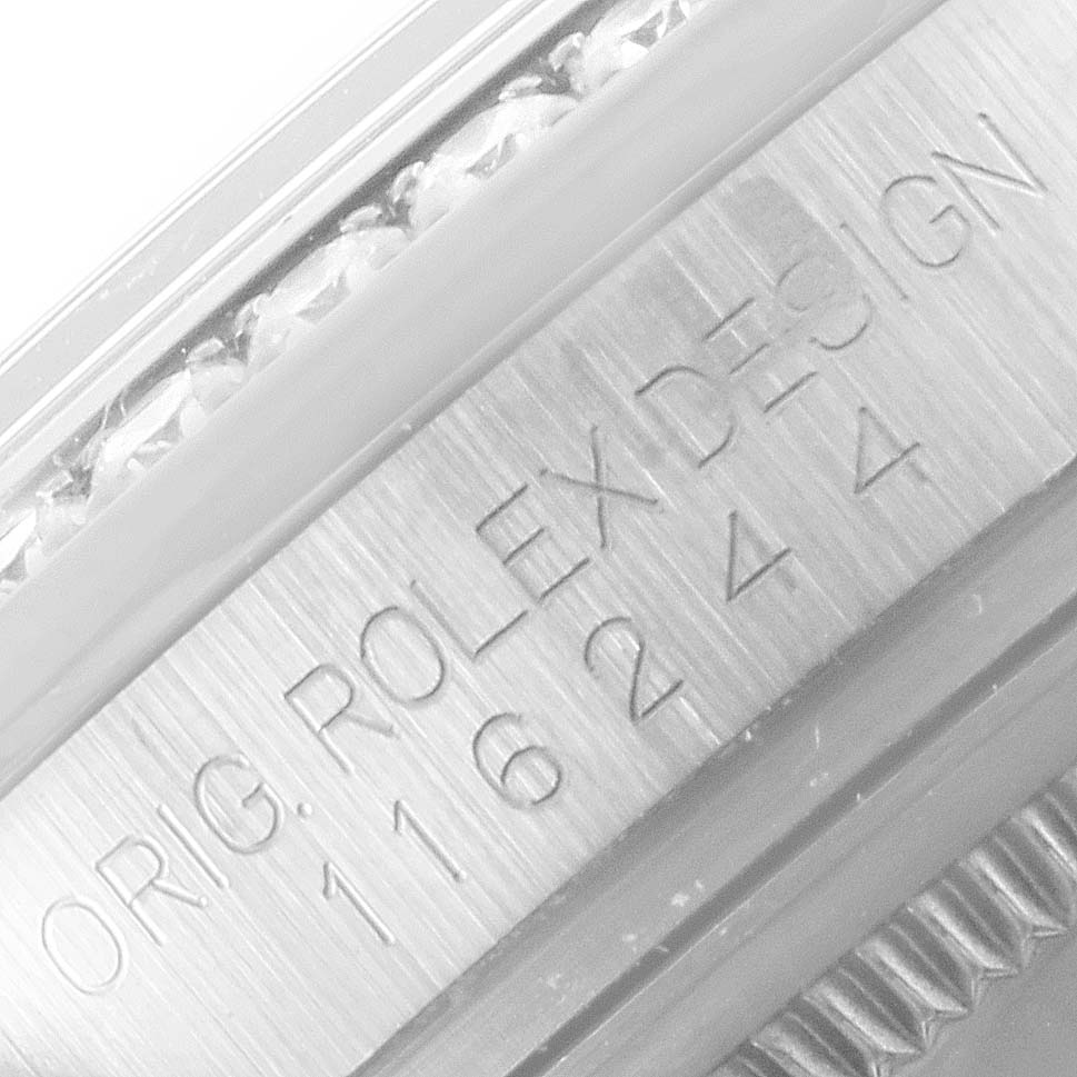 The image shows an engraved close-up of the side of the bezel and case of a Rolex Datejust 116244 Men
s Stainless Steel Black Dial 116244 Men
s Stainless Steel Black Dial watch.