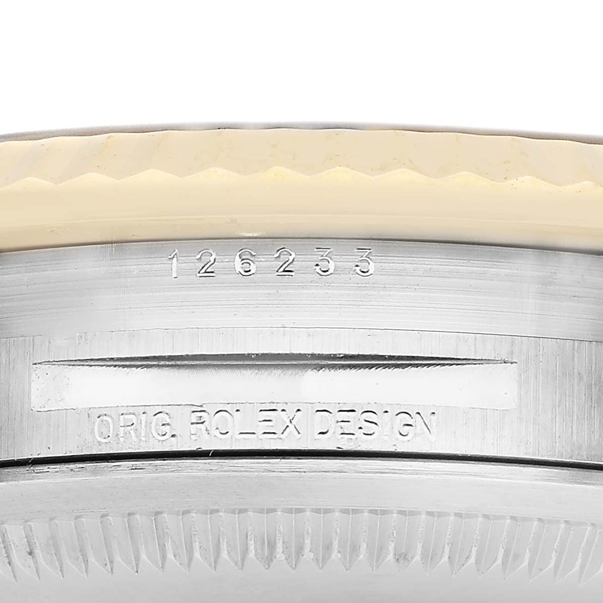 This image shows a close-up of the case side of a Rolex Datejust 126233 Men's Steel and Gold (two tone) Champagne Dial, with engraved model number.