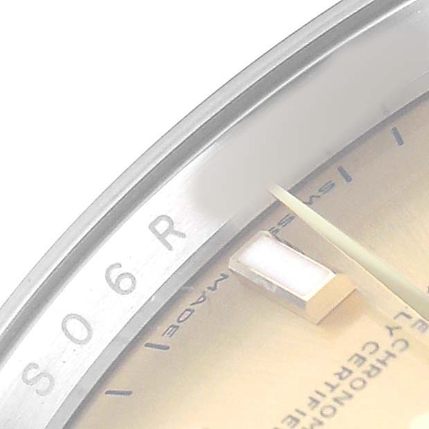 The image shows a close-up of the Rolex Datejust 126233 Men's Steel and Gold (two tone) Champagne Dial watch's dial, bezel edge, and part of the hour marker at an oblique angle.
