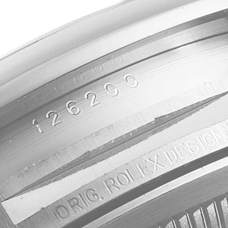 Close-up of the serial number and part of the case on a Rolex Datejust 126200 Men's Stainless Steel Silver Dial 126200 Men's Stainless Steel Silver Dial watch.