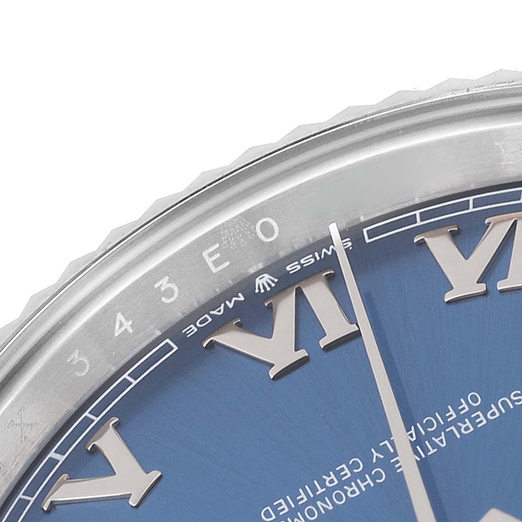 The image shows a close-up of the bezel and part of the blue dial with Roman numerals on a Rolex Datejust 41 126334 Men's Stainless Steel Blue Dial 126334 Men's Stainless Steel Blue Dial watch.