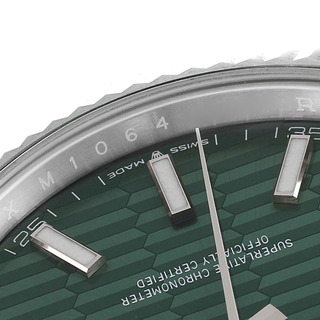 This image shows a close-up of the Rolex Datejust 41 126334 Men
s Stainless Steel Green Dial 126334 Men
s Stainless Steel Green Dial watch face, focusing on the indices, hands, and part of the bezel.