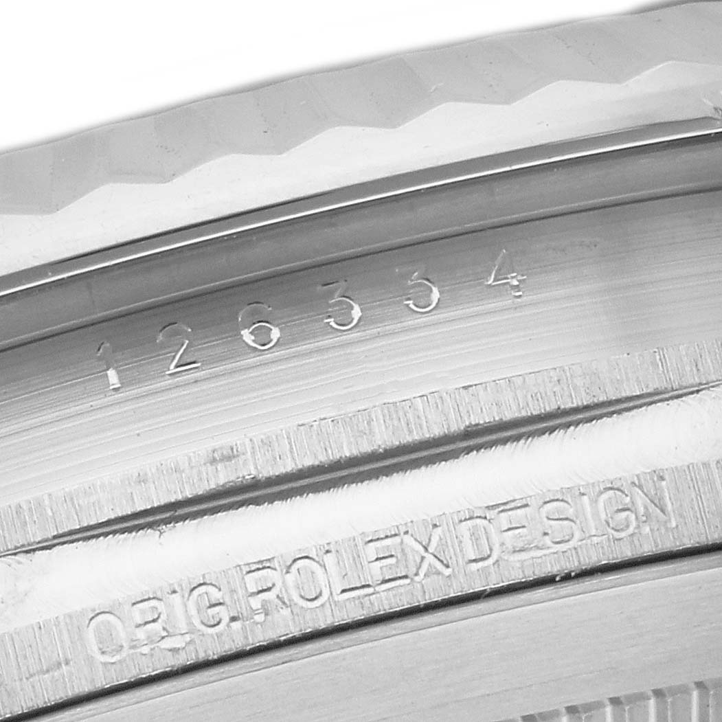 The image shows a close-up of the serial number and "ORIG ROLEX DESIGN" engraving on the case of a Rolex Datejust 41 126334 Men
s Stainless Steel Silver Dial 126334 Men
s Stainless Steel Silver Dial model.