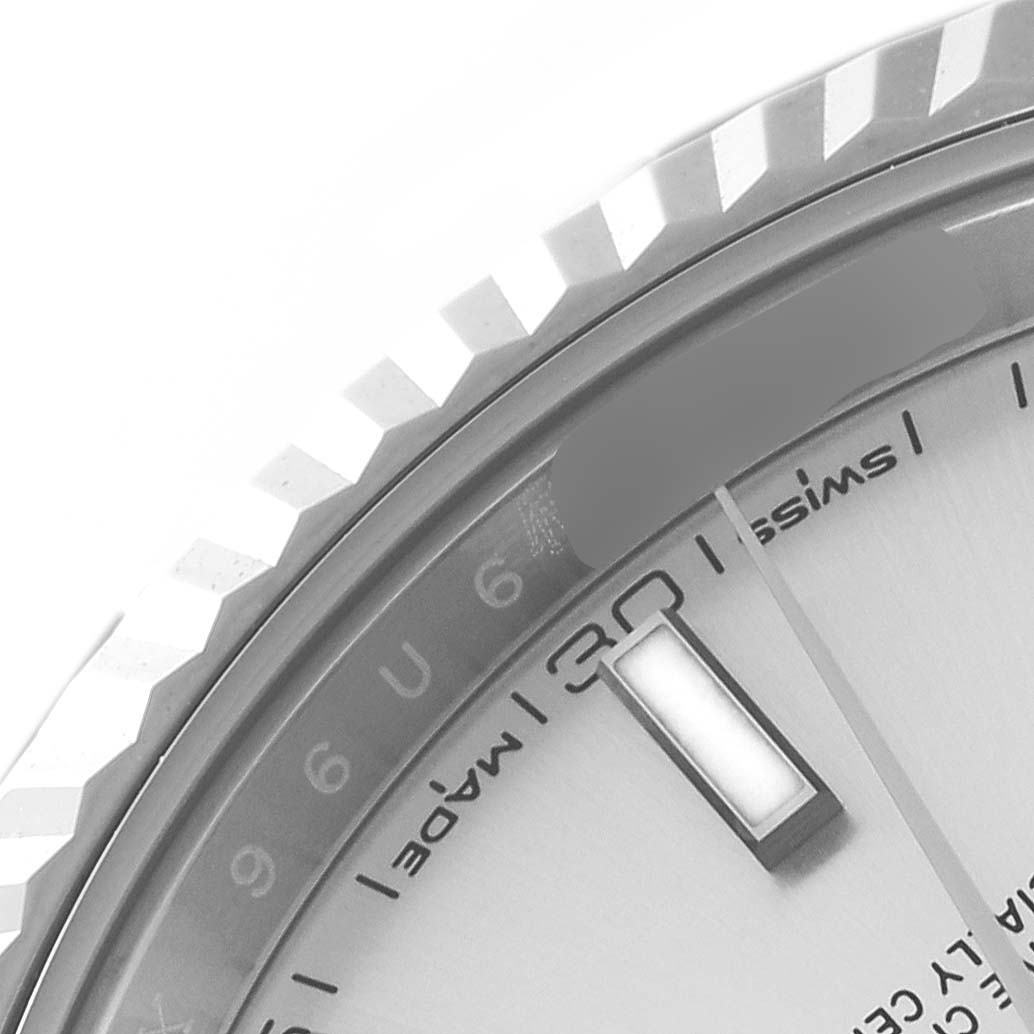 This close-up image of the Rolex Datejust 41 126334 Men
s Stainless Steel Silver Dial 126334 Men
s Stainless Steel Silver Dial shows the bezel, part of the dial, and hour marker.