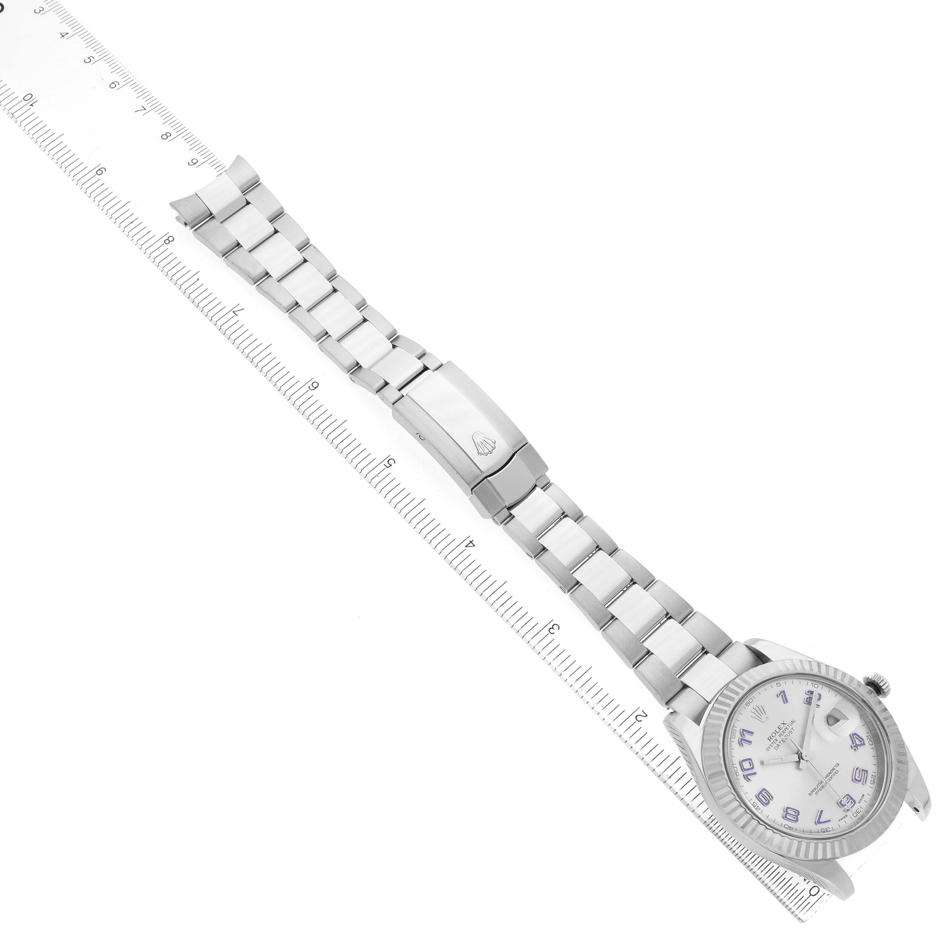 The Rolex Datejust 41 116334 Men's Stainless Steel Black Dial watch is shown at an angle highlighting the face, bezel, bracelet, and clasp, aligned next to a ruler.