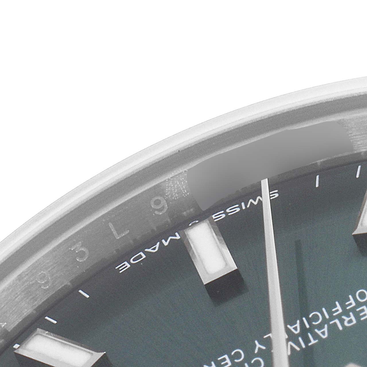 The image shows a close-up view of a portion of the dial and bezel of a Mid-Size Rolex watch.