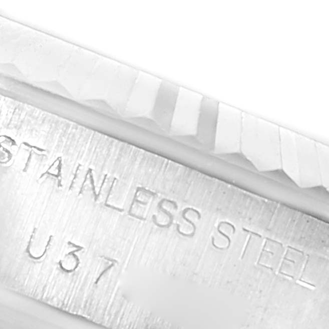 This image shows a close-up of the bezel and part of the case back with engraved text on a Rolex Datejust 69174 Women's Stainless Steel Black Dial 69174 Women's Stainless Steel Black Dial watch.