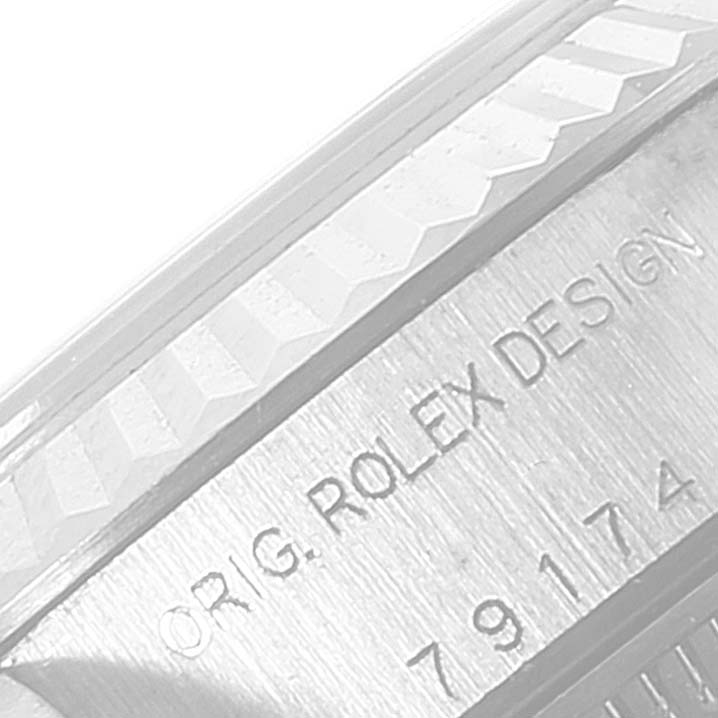 This image shows a close-up of a serial number and the text "ORIG. ROLEX DESIGN" on the Rolex Datejust 79174 Women's Stainless Steel White Dial 79174 Women's Stainless Steel White Dial model.