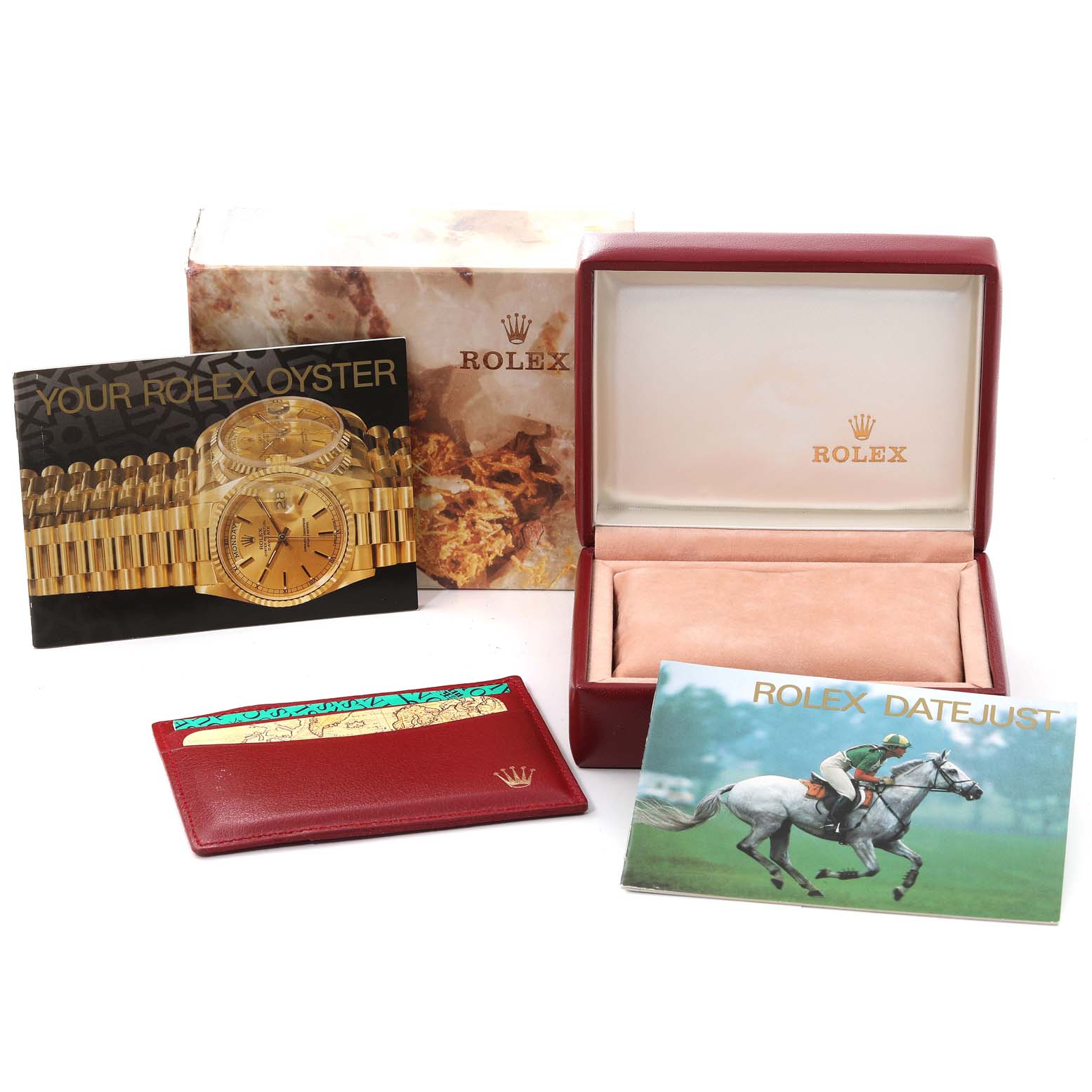 The image shows the packaging and accessories of a Rolex Datejust 69173 Women's Steel and Gold (two tone) Champagne Dial 69173 Women's Steel and Gold (two tone) Champagne Dial, including the box, manuals, and cardholder.