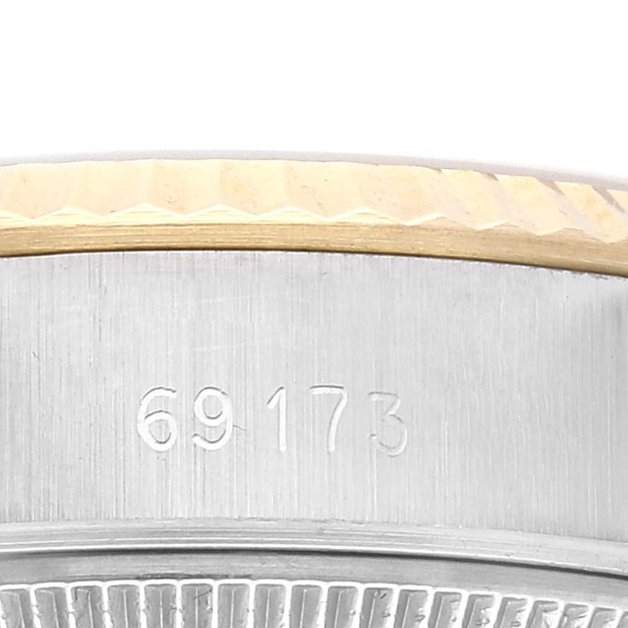 The image shows a close-up of the side case and bezel of a Rolex Datejust 69173 Women's Steel and Gold (two tone) Champagne Dial 69173 Women's Steel and Gold (two tone) Champagne Dial watch model 69173.