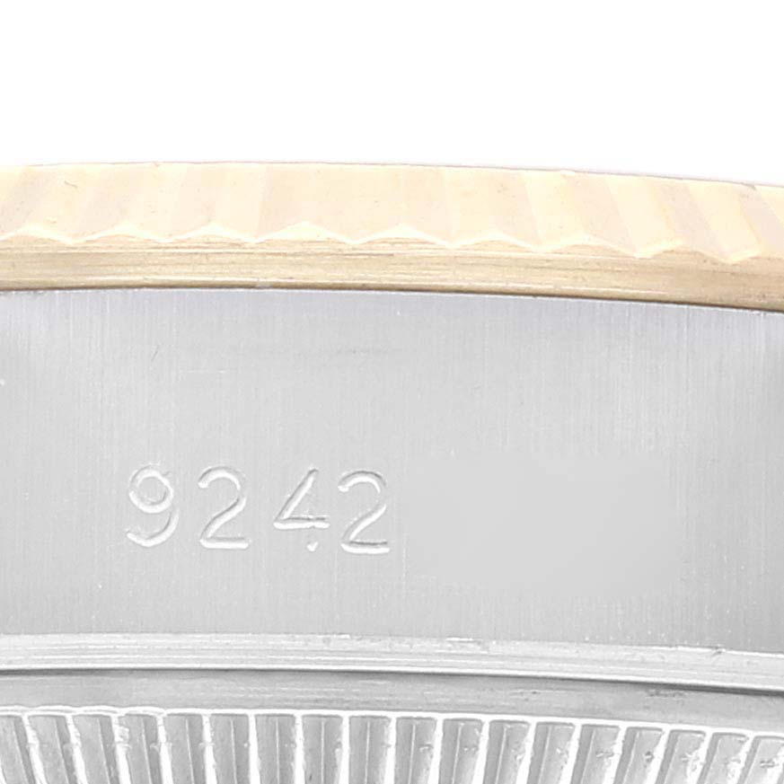 This close-up image shows the side view of the bezel and serial engraving of a Rolex Datejust 69173 Women's Steel and Gold (two tone) Champagne Dial 69173 Women's Steel and Gold (two tone) Champagne Dial watch.