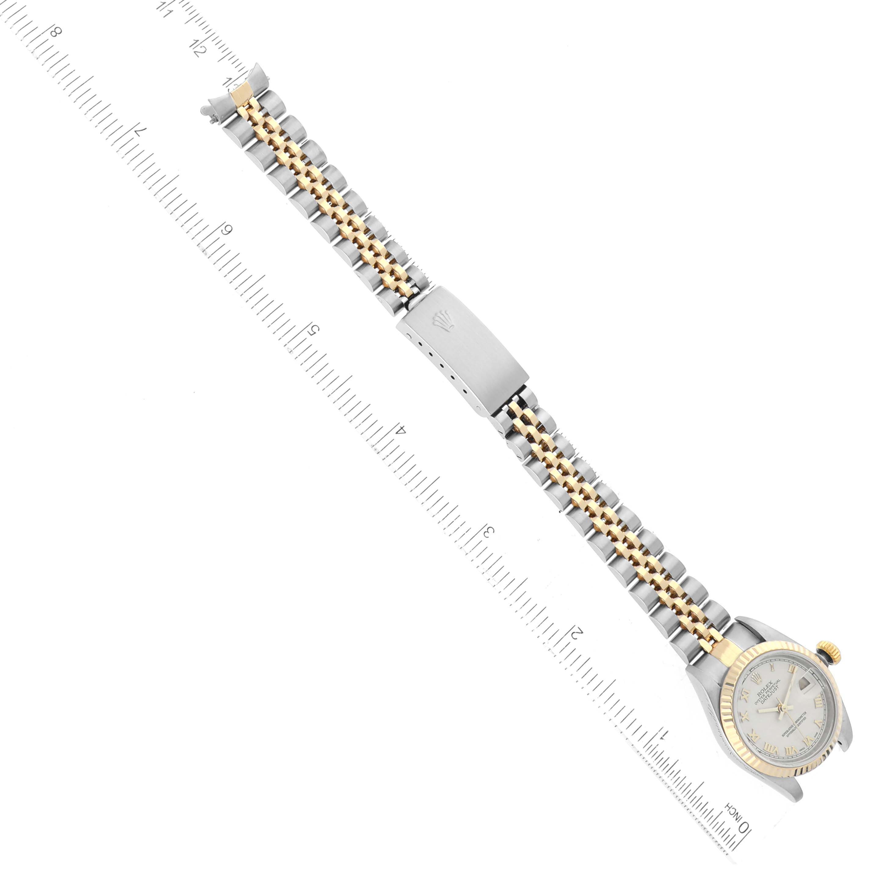 The image shows a top-down view of a Rolex Datejust 79173 Women's Steel and Gold (two tone) Beige Dial 79173 Women's Steel and Gold (two tone) Beige Dial watch, displaying its watch face, band, and clasp next to a measurement ruler.