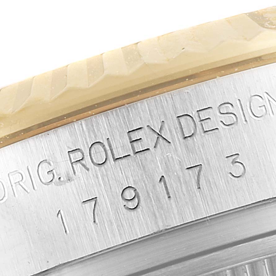 This image shows a close-up of the side of the Datejust Rolex watch, highlighting the engraved serial number and part of the bezel.