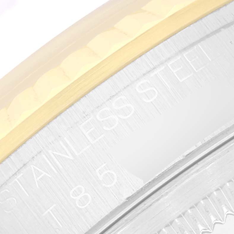 The image shows a close-up of the Rolex Datejust 16233 Men's Steel and Gold (two tone) Mother of Pearl Dial 16233 Men's Steel and Gold (two tone) Mother of Pearl Dial's case side and bezel, featuring "Stainless Steel" engraving.