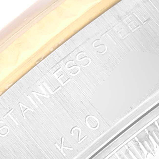 This close-up image shows the stainless steel and gold parts of a Rolex Datejust 79173 Women's Steel and Gold (two tone) Grey Dial 79173 Women's Steel and Gold (two tone) Grey Dial watch, including engraved text.