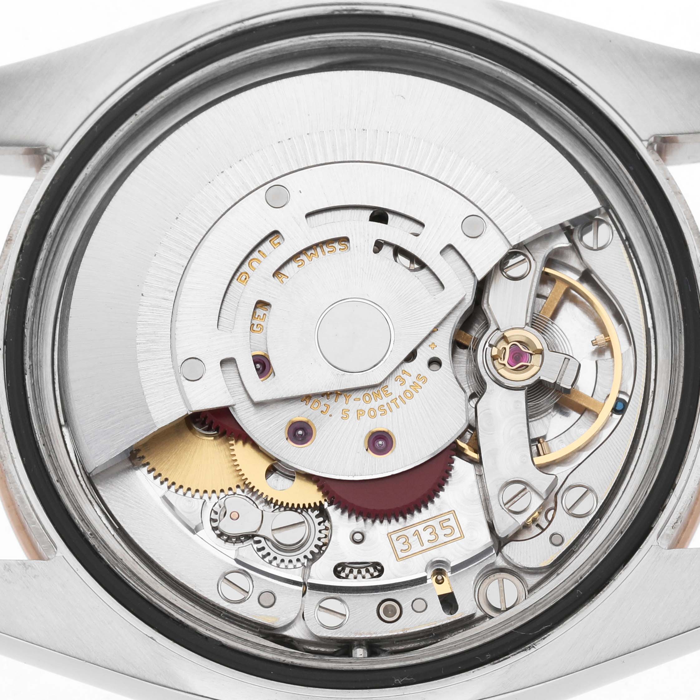 The image shows the back view of a Rolex Turn-o-Graph 116261 Men's Steel and Gold (two tone) White Dial, highlighting its intricate movement and gears.