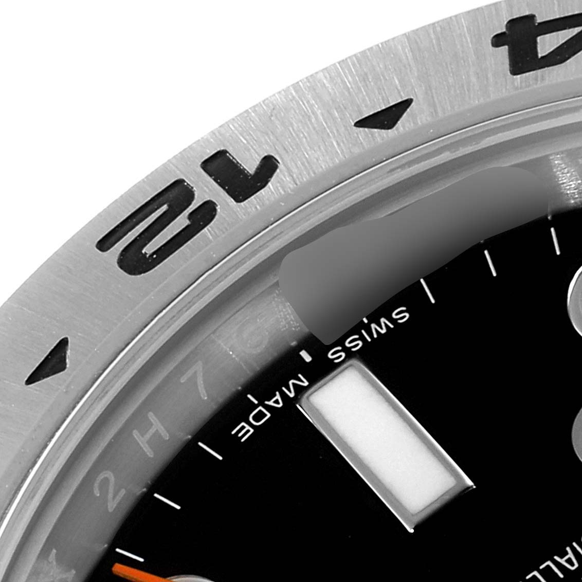 The image shows a close-up angle of the bezel and part of the dial of a Rolex Explorer 216570 Men's Stainless Steel Black Dial 216570 Men's Stainless Steel Black Dial watch.