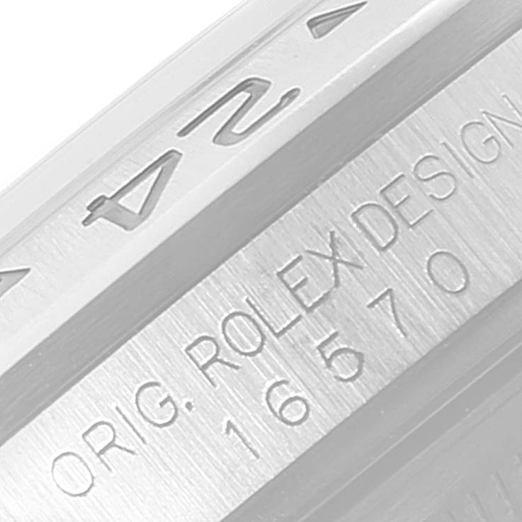 The image shows a close-up of the side of a Rolex Explorer 16570 Men's Stainless Steel Black Dial 16570 Men's Stainless Steel Black Dial watch, highlighting the engraved serial and design numbers.