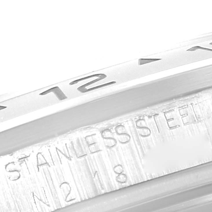 The image shows a close-up of the bezel and part of the case back of a Rolex Explorer 16570 Men's Stainless Steel Black Dial 16570 Men's Stainless Steel Black Dial model, with "STAINLESS STEEL" engraved.