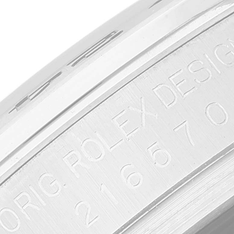 This image shows a close-up of the engraved serial number on the side of a Rolex Explorer 216570 Men
s Stainless Steel Black Dial 216570 Men
s Stainless Steel Black Dial watch.