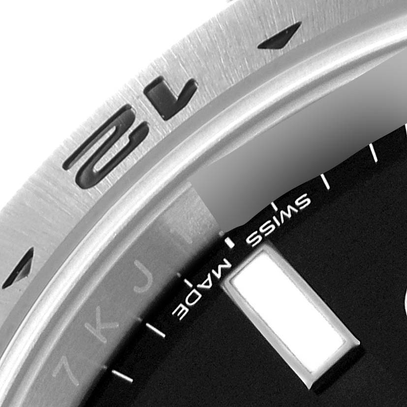 Close-up image of the bezel, part of the dial, and the "Swiss Made" text on a Rolex Explorer 216570 Men
s Stainless Steel Black Dial 216570 Men
s Stainless Steel Black Dial watch.