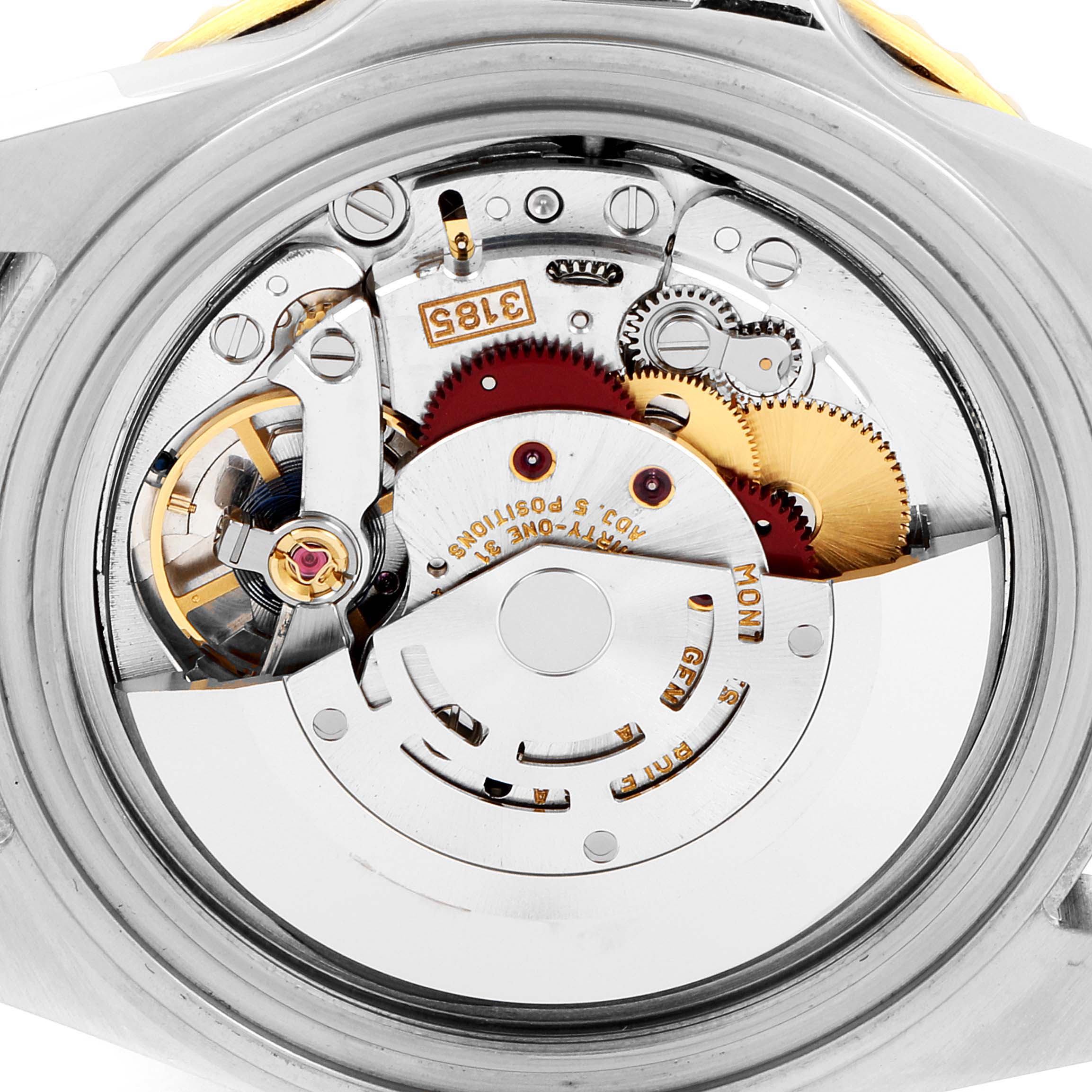 This image shows the internal mechanism of a Rolex GMT-Master 16713 Men's Steel and Gold (two tone) Black Dial 16713 Men's Steel and Gold (two tone) Black Dial watch from a rear angle, revealing its intricate components.