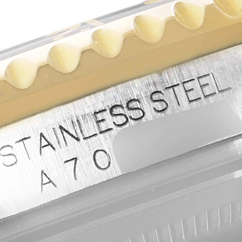 This close-up image shows the side engraving, detailing "Stainless Steel" and partial serial number of a Rolex GMT-Master 16713 Men's Steel and Gold (two tone) Black Dial 16713 Men's Steel and Gold (two tone) Black Dial watch.