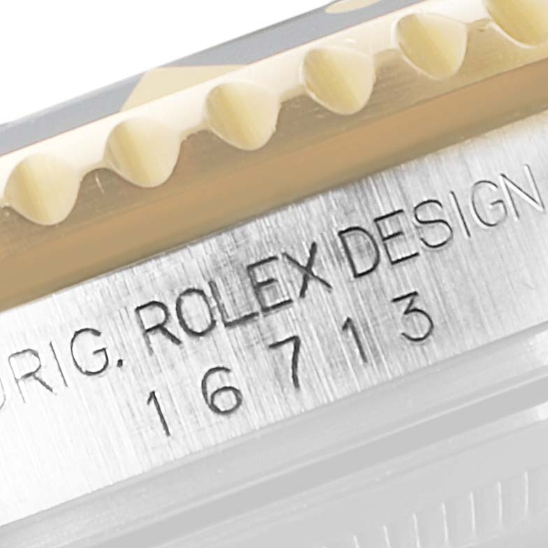This close-up image shows the engraved side profile of a Rolex GMT-Master 16713 Men's Steel and Gold (two tone) Black Dial 16713 Men's Steel and Gold (two tone) Black Dial watch, featuring the model number 16713.
