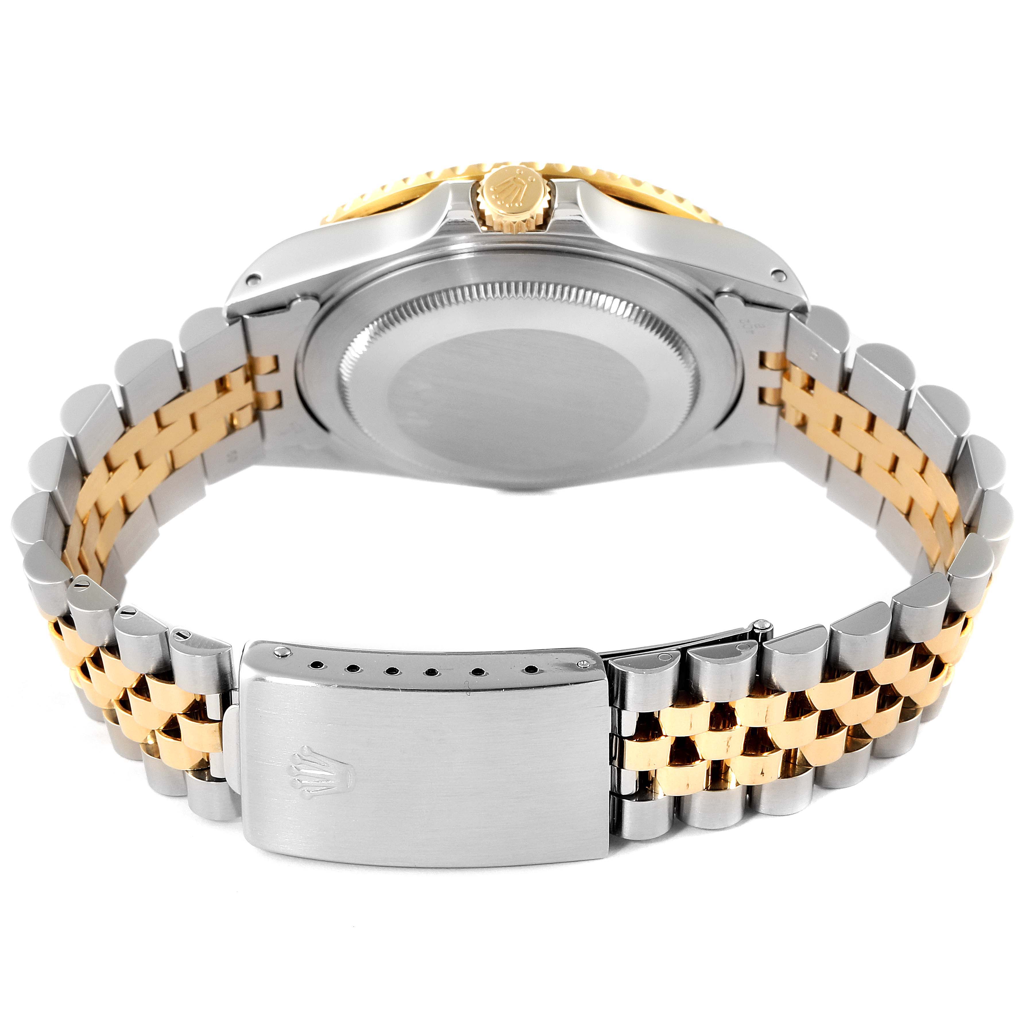 This image shows the back case and bracelet of a Rolex GMT-Master 16713 Men's Steel and Gold (two tone) Black Dial 16713 Men's Steel and Gold (two tone) Black Dial watch, featuring a two-tone metal design.