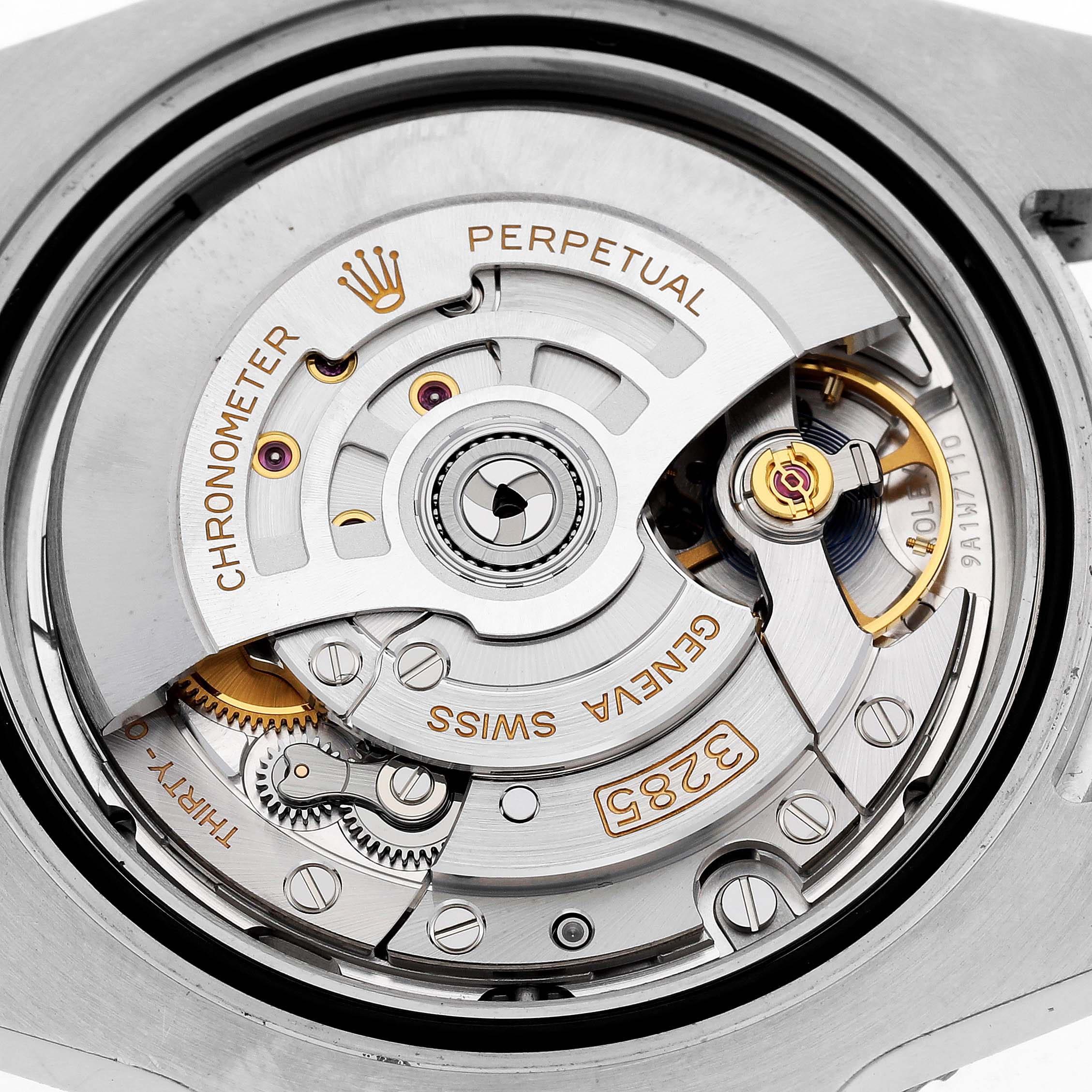 The image shows the movement mechanism of a Rolex GMT-Master 126713GRNR Men's Steel and Gold (two tone) Black Dial, viewed from the back, highlighting the intricate internal components.