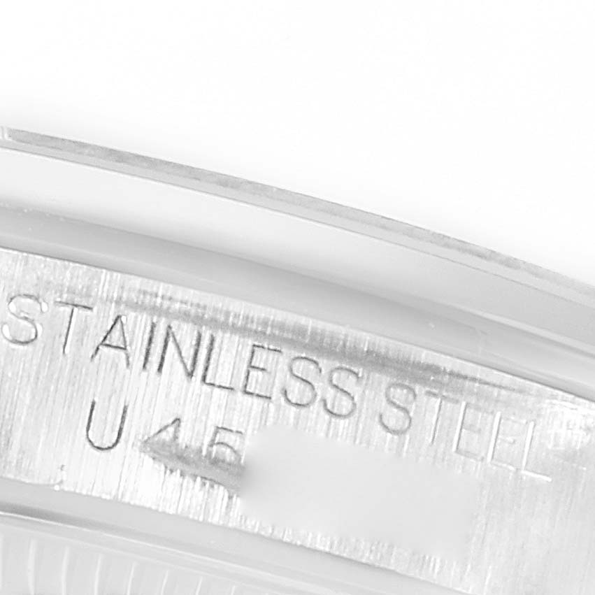 The image shows a close-up of the inner case with "STAINLESS STEEL" engraved on a Rolex Mid-Size 67480 Women's Stainless Steel Blue Dial 67480 Women's Stainless Steel Blue Dial watch.