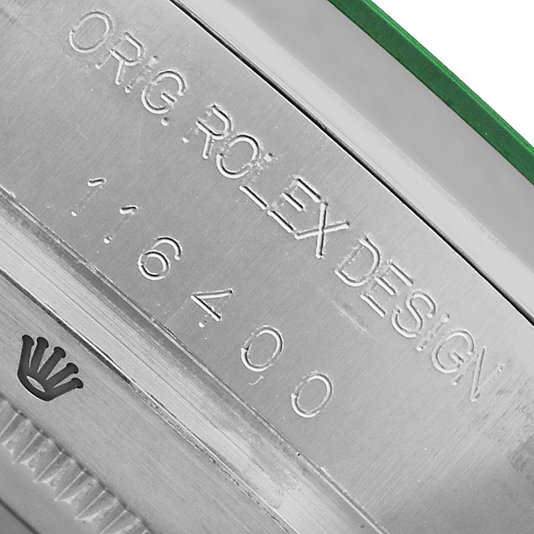 The image displays a close-up of the Rolex Milgauss 116400GV Men's Stainless Steel Black Dial model's serial engraving on the watch's case.