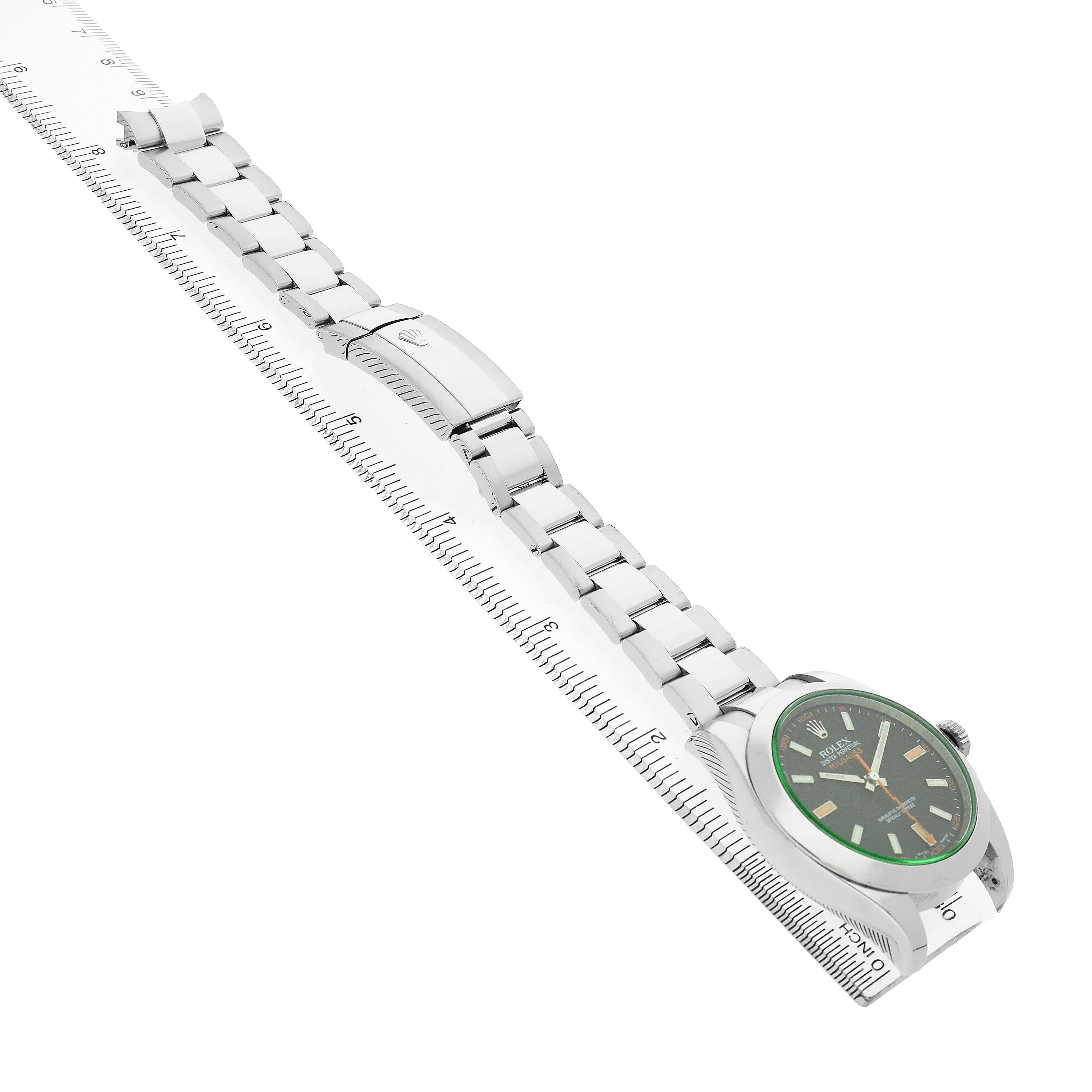 The Rolex Milgauss 116400GV Men's Stainless Steel Black Dial watch is shown from a side angle, displaying the dial and bracelet with a ruler for scale.