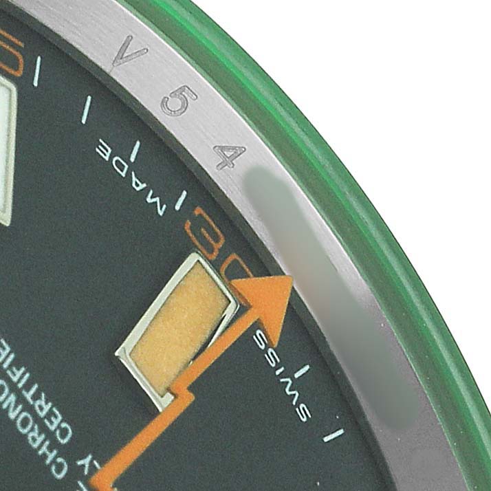 The image shows a close-up of the Rolex Milgauss 116400GV Men's Stainless Steel Black Dial watch face, highlighting the orange seconds hand, indices, and partial minute markers.