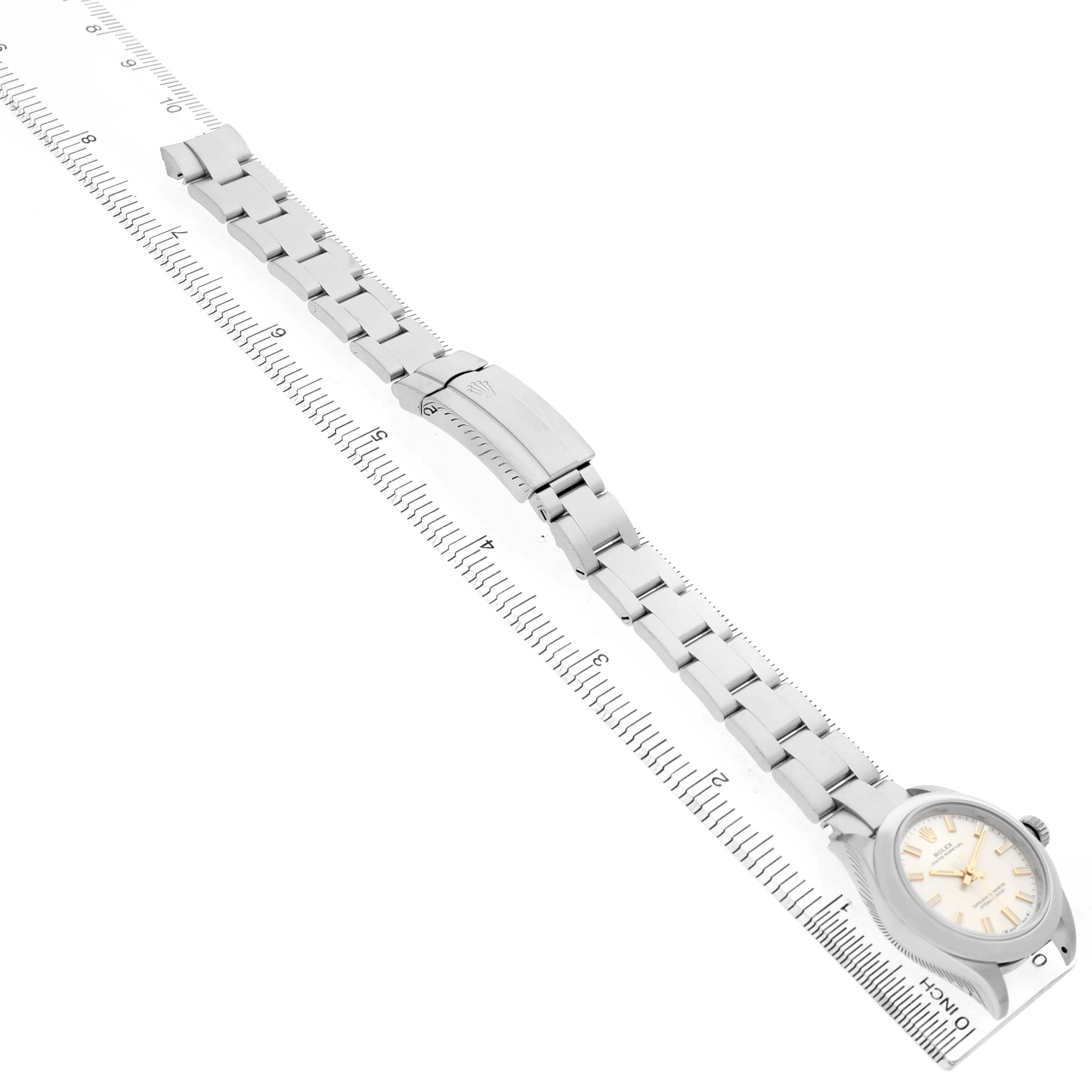 The Rolex Oyster Perpetual 276200 Women's Stainless Steel Silver Dial watch is shown diagonally, displaying the face, full bracelet, and clasp.