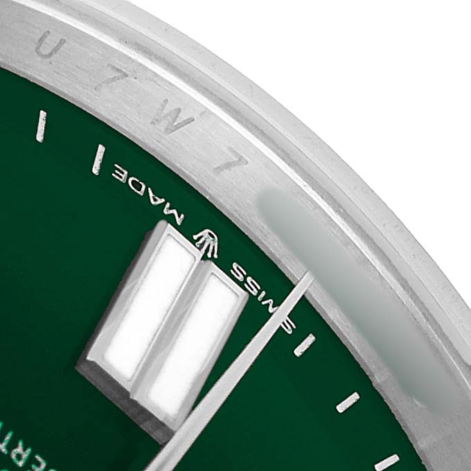 The image shows a close-up of the Rolex Oyster Perpetual 134300 Men's Stainless Steel Green Dial watch dial, highlighting the indices and "SWISS MADE" text.