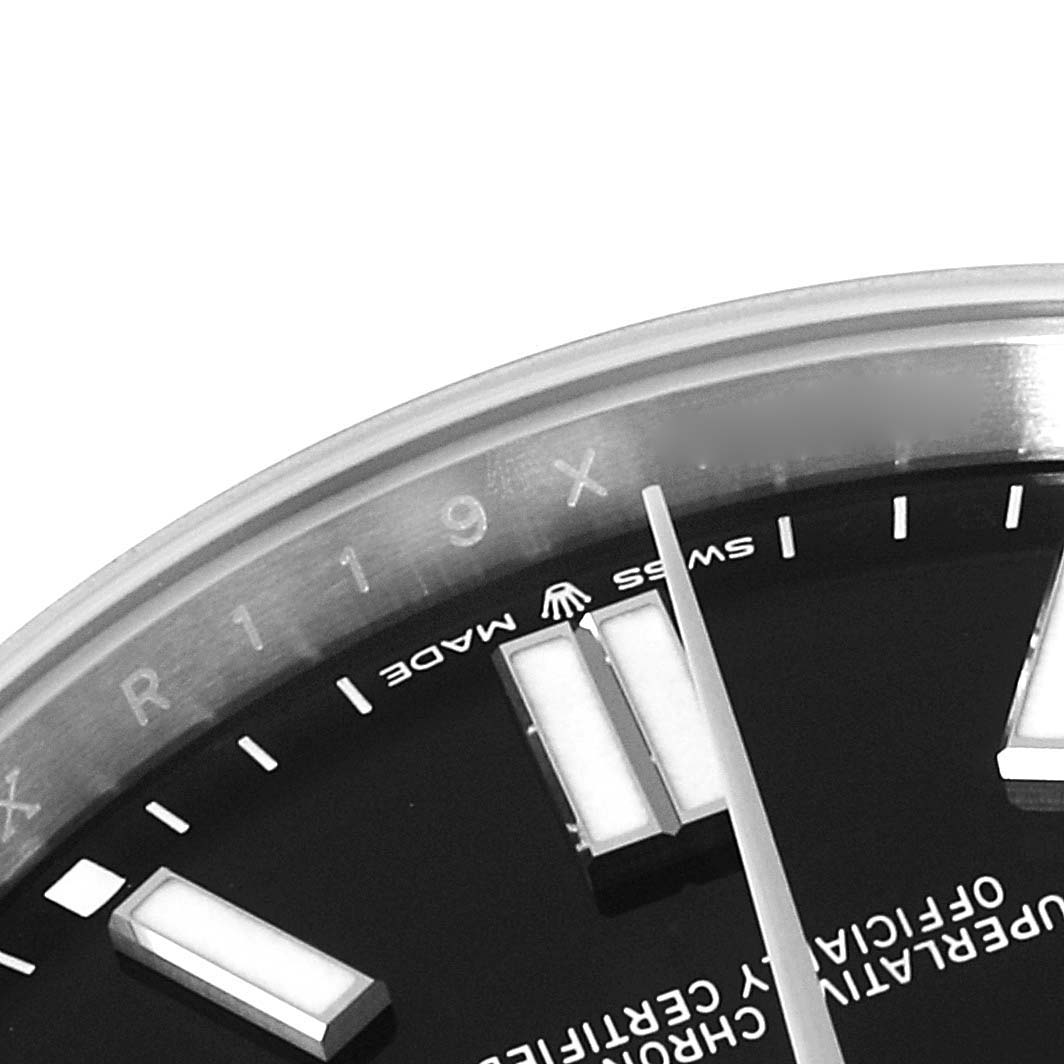 This image shows a close-up of the face and bezel of a Rolex Oyster Perpetual 124300 Men's Stainless Steel Black Dial 124300 Men's Stainless Steel Black Dial watch, focusing on the "Swiss Made" text and hour markers.