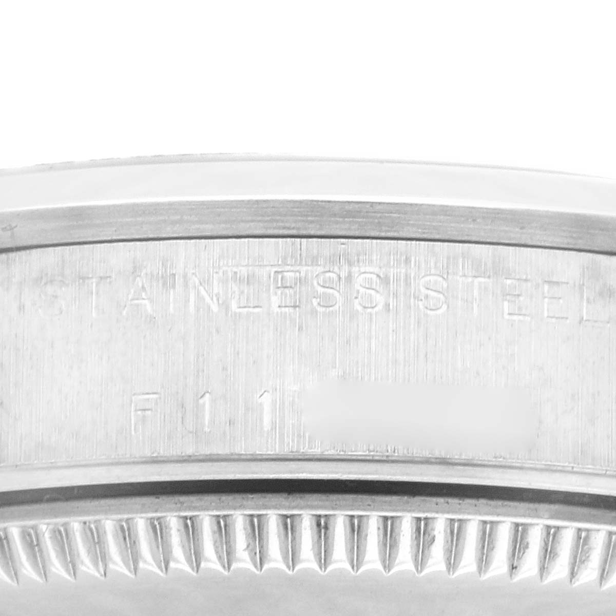 This close-up angle shows the side of the stainless steel case and bezel of a Mid-Size Rolex watch.