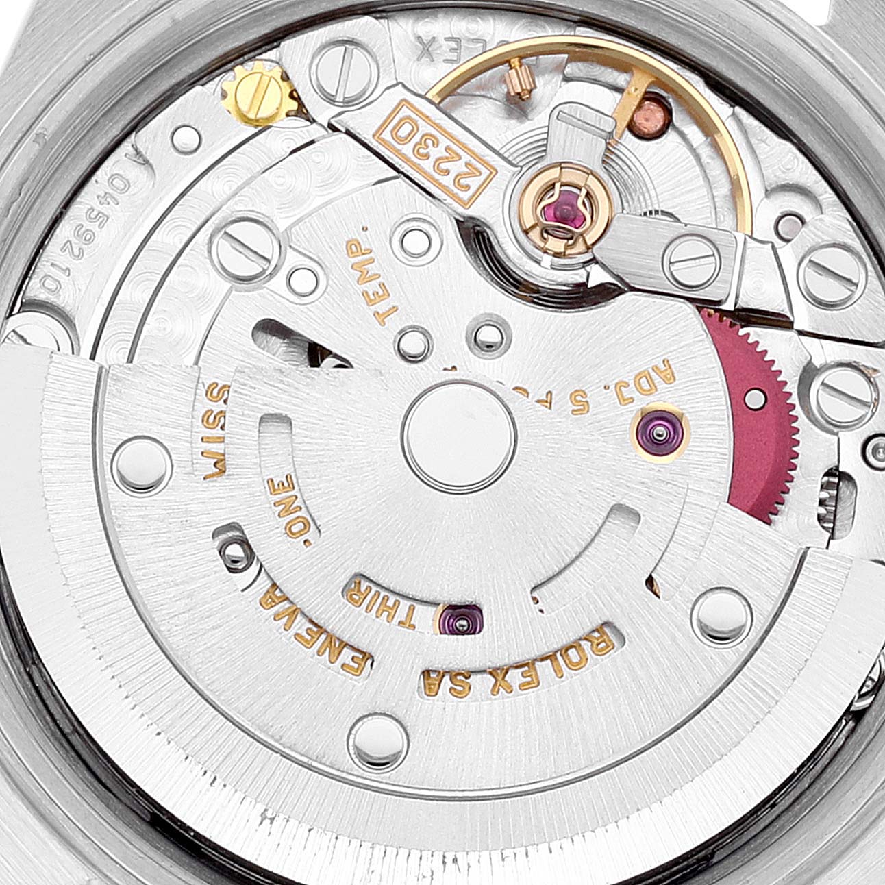 This image shows a close-up of the movement mechanism inside a Rolex Datejust 76030 Women's Stainless Steel Pink Dial 76030 Women's Stainless Steel Pink Dial watch, highlighting its intricate components and engravings.