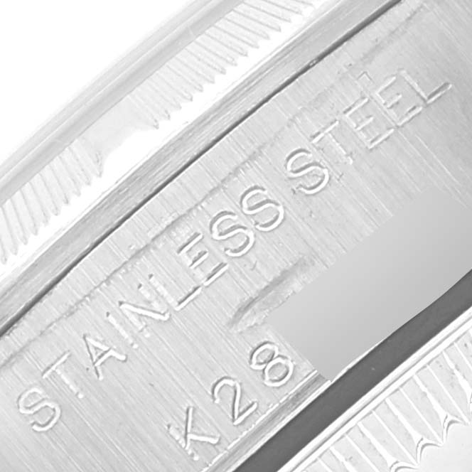 This image shows a close-up of the stainless steel engravings and serial number on the case of a Rolex Datejust 76030 Women's Stainless Steel Pink Dial 76030 Women's Stainless Steel Pink Dial watch.