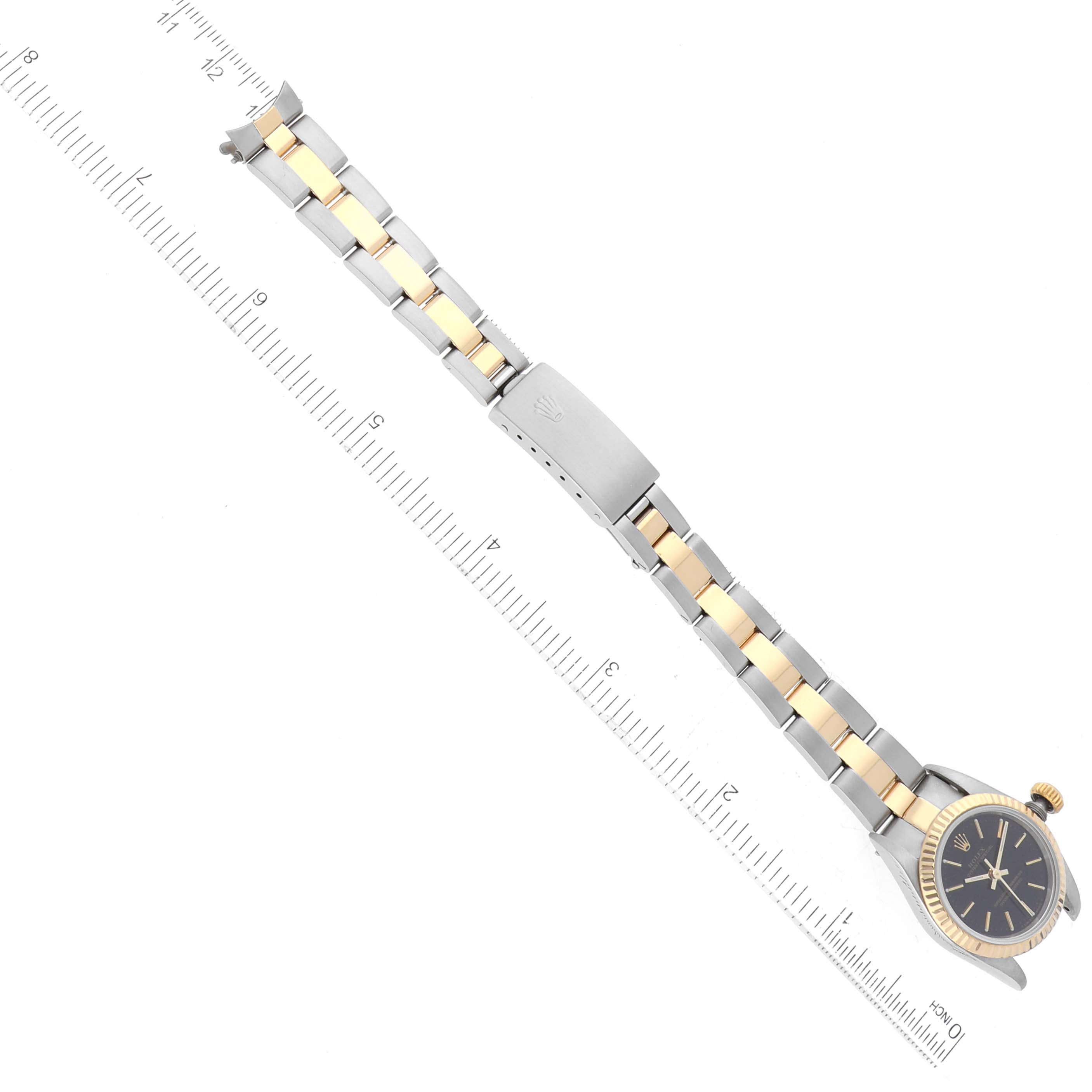 The image shows a Rolex Oyster Perpetual 67193 Women's Steel and Gold (two tone) Black Dial 67193 Women's Steel and Gold (two tone) Black Dial watch at a top-down angle, highlighting the face, crown, and two-tone bracelet with a clasp.
