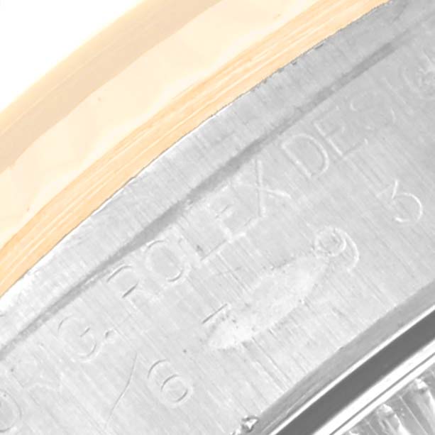 This image shows a close-up of the case edge with the engraved text of a Rolex Oyster Perpetual 67193 Women's Steel and Gold (two tone) Black Dial 67193 Women's Steel and Gold (two tone) Black Dial watch, specifically highlighting the model number area.