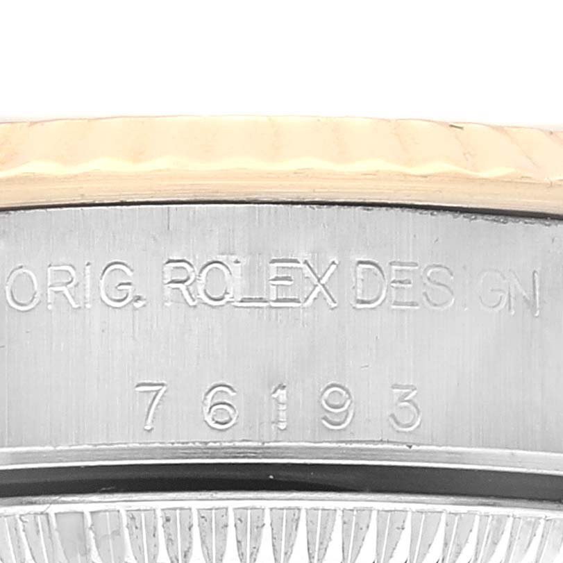 The image shows a close-up of the engraved side of a Rolex Oyster Perpetual 76193 Women's Steel and Gold (two tone) White Dial 76193 Women's Steel and Gold (two tone) White Dial watch case, displaying "ORIG. ROLEX DESIGN" and the model number.