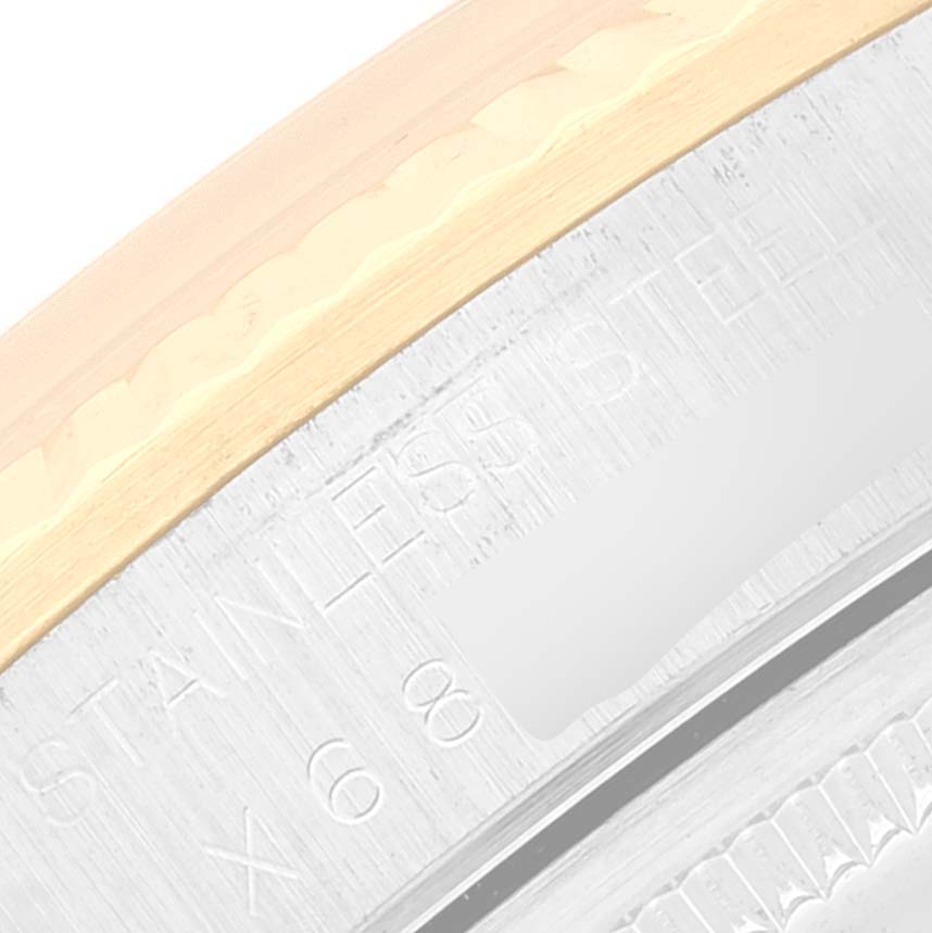 This image shows a close-up of the stainless steel and gold edge of a Rolex Oyster Perpetual 14233 Men's Steel and Gold (two tone) White Dial 14233 Men's Steel and Gold (two tone) White Dial watch case.