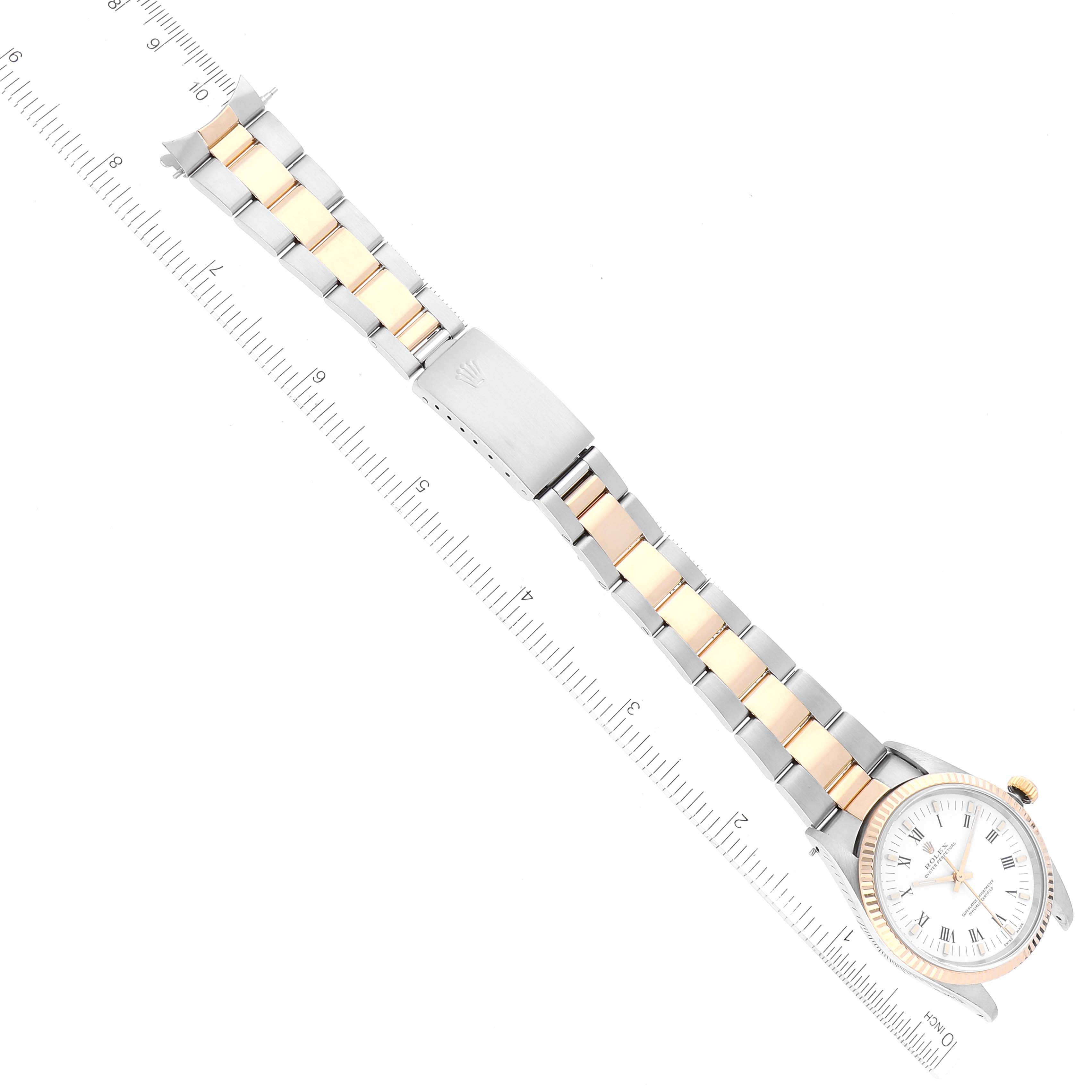 The image shows a Rolex Oyster Perpetual 14233 Men's Steel and Gold (two tone) White Dial 14233 Men's Steel and Gold (two tone) White Dial watch laid flat, with the dial, bracelet, and clasp visible, alongside a ruler for scale.
